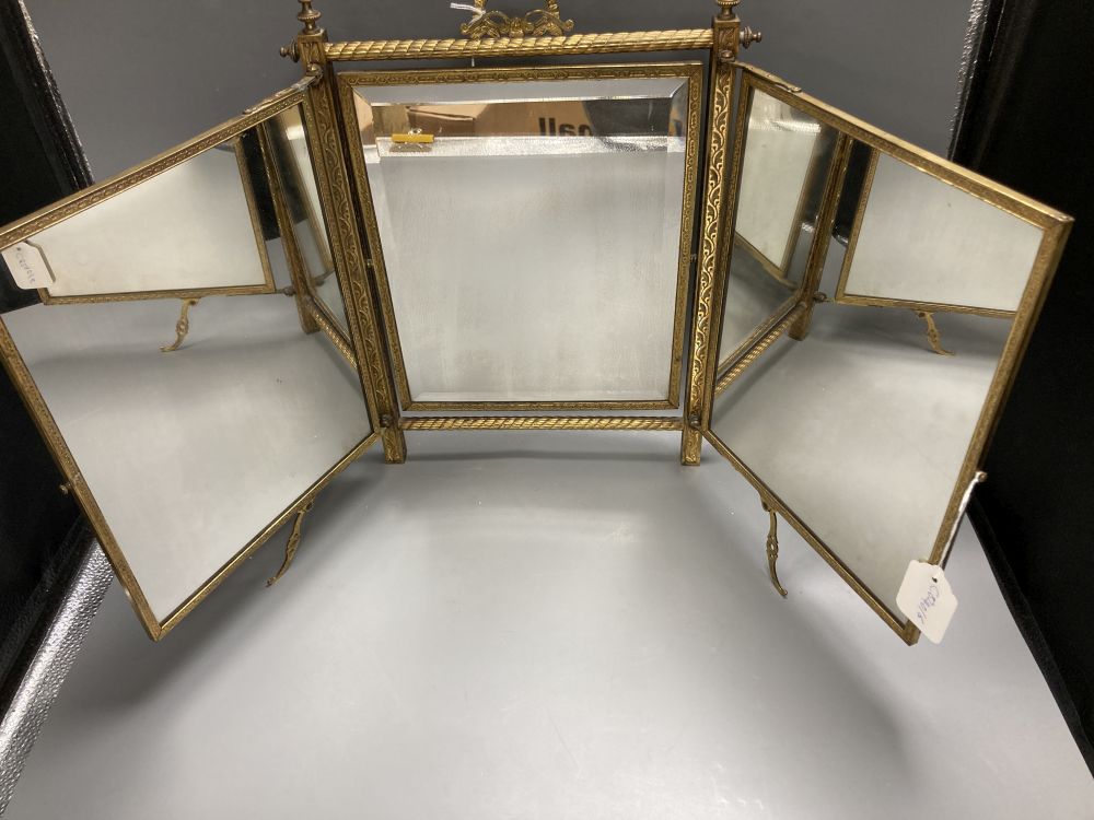 A gilt framed triptych mirror with faux ivory angelic panel and similar floral painted panel, height 41cm